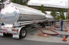 Two Sail Energy oil tankers refueling at a gas station. 